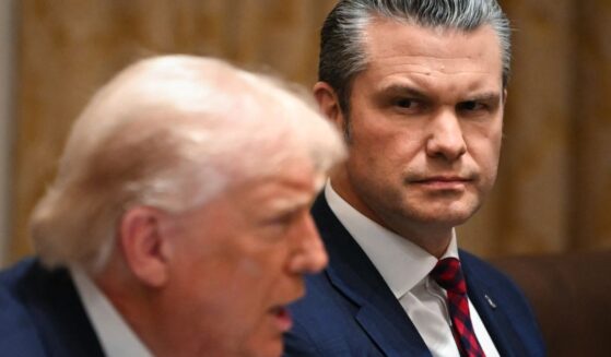 President Donald Trump speaks alongside Secretary of War Pete Hegseth during a Cabinet meeting in the White House in Washington, D.C., on Dec. 2, 2025.