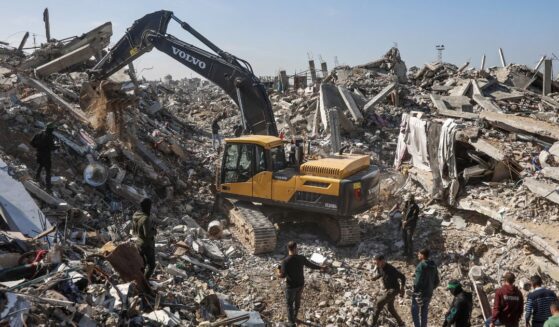 Palestinian Hamas militants and Egyptian workers accompanied by members of the International Committee of the Red Cross use a digger as they search for the last two remaining bodies of hostages, an Israeli soldier and a Thai national, under the rubble of the Jabalia refugee camp, in the northern of Gaza Strip on Dec. 1, 2025.