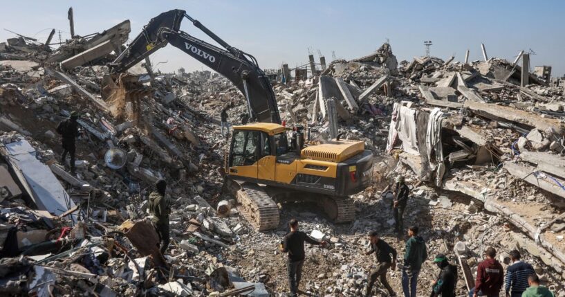 Palestinian Hamas militants and Egyptian workers accompanied by members of the International Committee of the Red Cross use a digger as they search for the last two remaining bodies of hostages, an Israeli soldier and a Thai national, under the rubble of the Jabalia refugee camp, in the northern of Gaza Strip on Dec. 1, 2025.