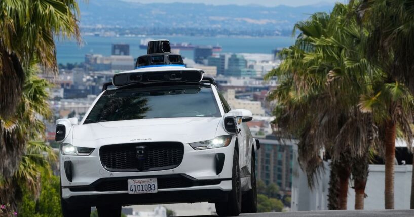 A Waymo car drives up a hill in San Francisco on Sept. 4, 2025.