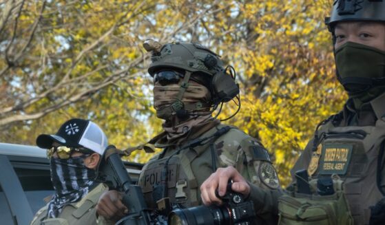 Federal agents searching for illegal aliens pause in a park to regroup on Nov. 6, 2025, in Chicago, Illinois.