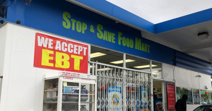 A sign noting the acceptance of EBT cards that are used by state welfare departments to issue benefits is displayed at a convenience store on Dec. 4, 2019, in Richmond, California.