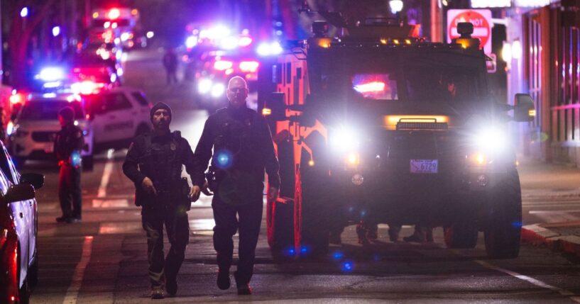Police officers remain on the scene of a shooting that killed two and wounded at least eight at Brown University on Dec. 13, 2025, in Providence, Rhode Island.