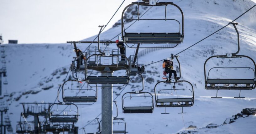 Ski lift operators practicing emergency response drills on a line of chairlift pylons at La Pierre Saint Martin in Arette, France, on Dec. 1, 2025.