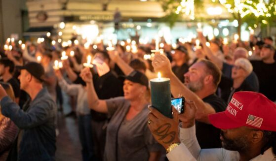 Attendees hold candles during a candlelight vigil and prayer event for Turning Point USA founder Charlie Kirk on Sept. 10, 2025, in Seattle, Washington.