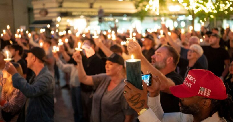 Attendees hold candles during a candlelight vigil and prayer event for Turning Point USA founder Charlie Kirk on Sept. 10, 2025, in Seattle, Washington.