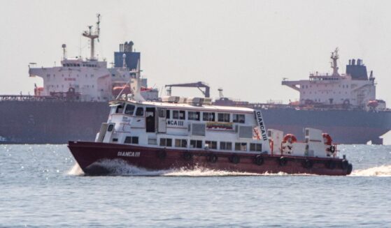 A boat sails in front of a crude oil tanker anchored on Lake Maracaibo near Maracaibo, Zulia state, Venezuela, on Dec. 18, 2025.