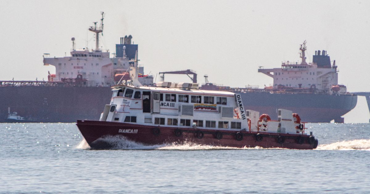 A boat sails in front of a crude oil tanker anchored on Lake Maracaibo near Maracaibo, Zulia state, Venezuela, on Dec. 18, 2025.