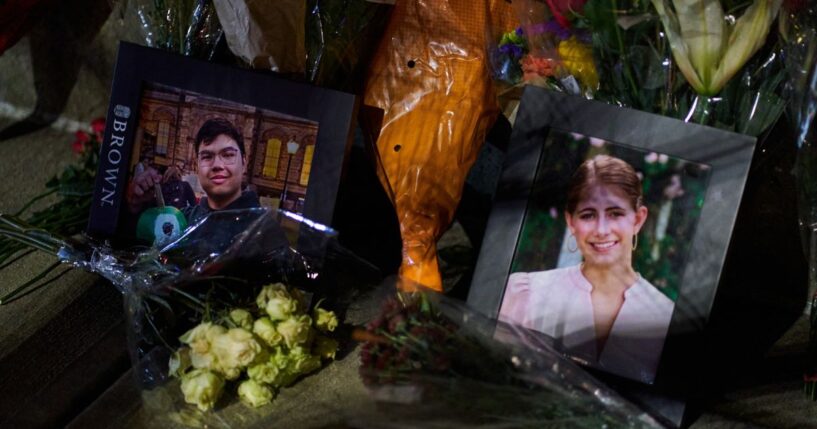 Framed photos of mass shooting victims Mukhammad Aziz Amurzokov and Ella Cook are seen Monday at a makeshift memorial near Brown University in Providence, Rhode Island.