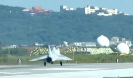 In this image taken off video, a Taiwan fighter jet lands Monday at the Hsinchu Air Base in Taiwan.