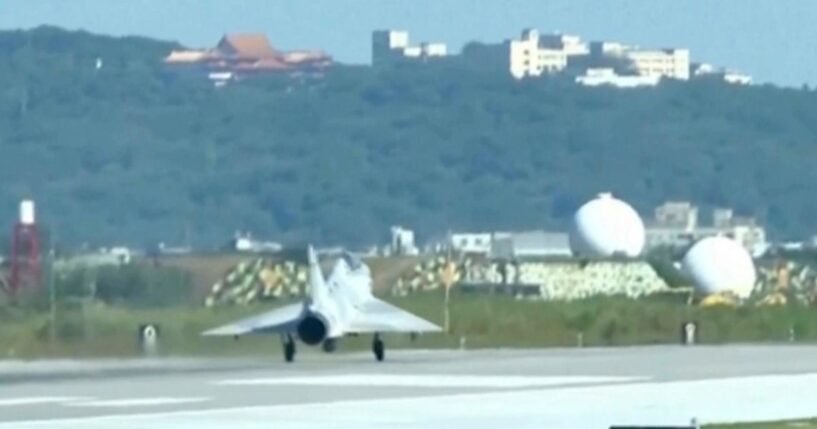 In this image taken off video, a Taiwan fighter jet lands Monday at the Hsinchu Air Base in Taiwan.