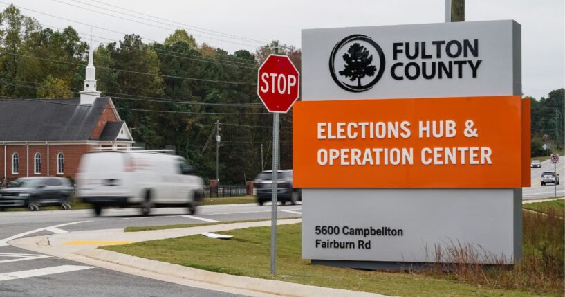 Vehicles pass by the sign for the Fulton County Elections Hub and Operations Center on Nov. 4, 2024, in Union City, Georgia.