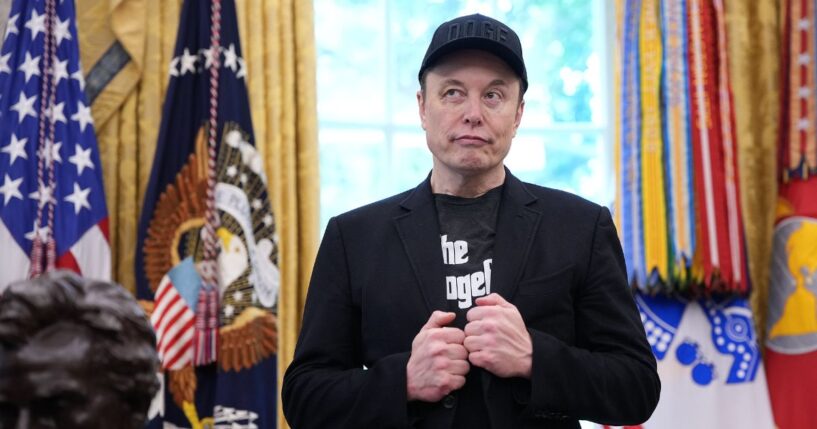 Elon Musk stands in the Oval Office of the White House as President Donald Trump speaks to reporters in Washington, DC on May 30, 2025.