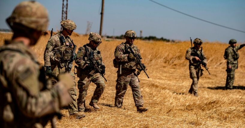 US soldiers walk with Turkish troops in the Syrian village of al-Hashisha on Sept. 8, 2019.
