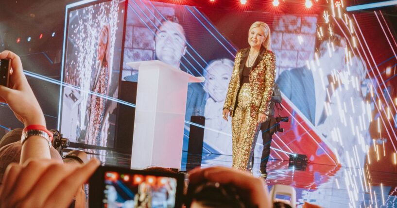 Turning Point USA CEO Erika Kirk walks onstage at AmericaFest in Phoenix, Arizona, on Dec. 18, 2025.