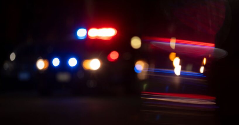 A blurry view of police lights flashing.