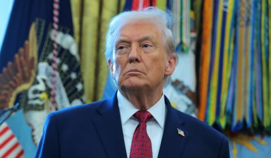 President Donald Trump listens during a ceremony in the Oval Office of the White House in Washington, DC on Dec. 15, 2025.
