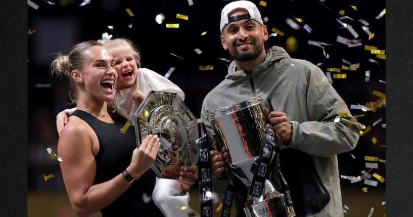 Runner-up Aryna Sabalenka and her goddaughter Nicole pose for a photo with Nick Kyrgios of Australia during the trophy ceremony following the Battle of the Sexes match between the two Sunday in Dubai, United Arab Emirates.