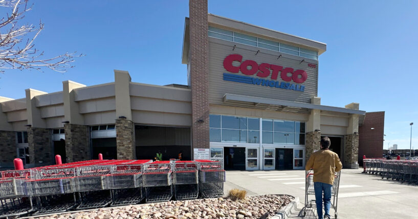 A lone shopper pushes a cart toward the entrance of a Costco warehouse on March 13, 2025, in Sheridan, Colorado.