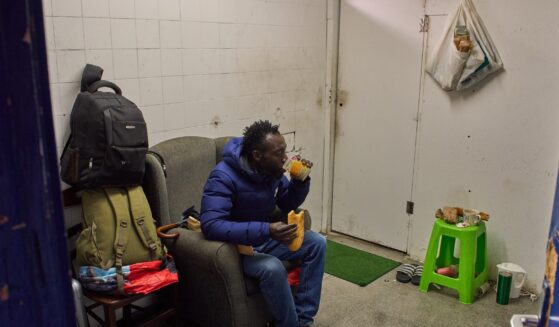 Yankuba Touray, from Gambia, eats his breakfast inside an abandoned school in Badalona, near Barcelona, Spain, on Dec. 16, 2025.