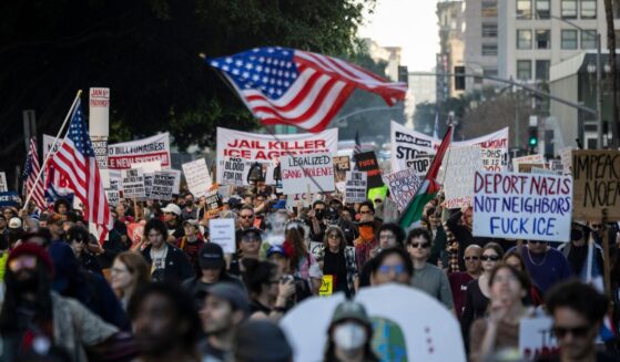 People wave flags and hold signs during a protest in Los Angeles, California, on Jan. 10, 2026, against U.S. Immigration and Customs Enforcement after the fatal shooting of Renee Nicole Good in Minneapolis, Minnesota.