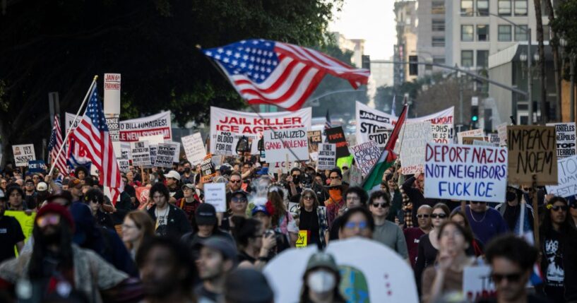 People wave flags and hold signs during a protest in Los Angeles, California, on Jan. 10, 2026, against U.S. Immigration and Customs Enforcement after the fatal shooting of Renee Nicole Good in Minneapolis, Minnesota.