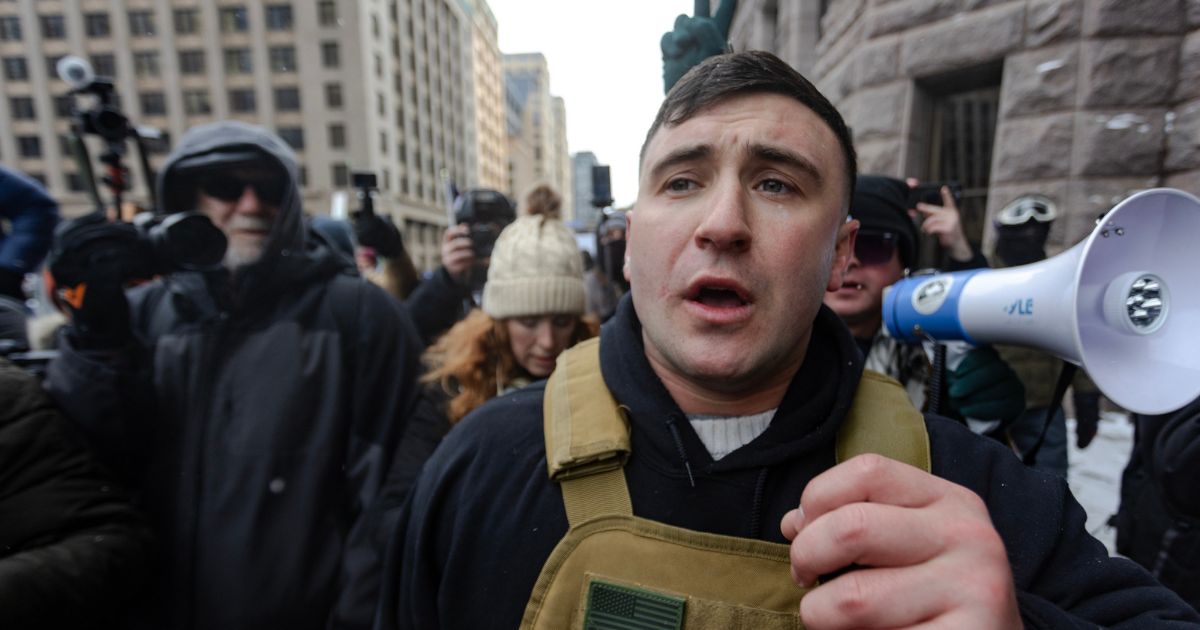 Right wing influencer Jake Lang is confronted by protesters at a rally near city hall on Jan. 17, 2026, in Minneapolis, Minnesota.