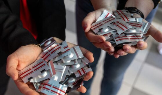 Polish pro-abortion activist Justyna Wydrzynska of the "Abortion Dream Team" women's rights group and Manon Aubry from La France Insoumise present abortion pills donated by representatives of LFI for Poland's first activist-run abortion consultation point in Warsaw, Poland, on April 29, 2025.