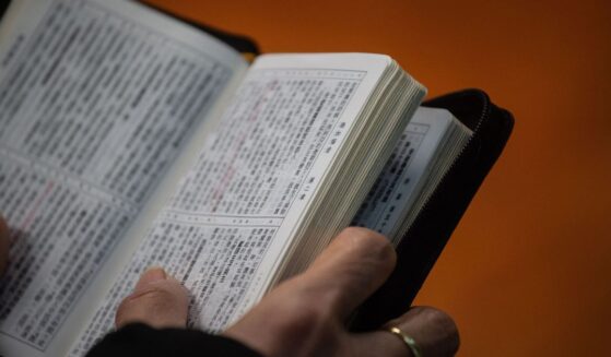 A worshipper holds a copy of the Bible while attending a church service ahead of Christmas in Hong Kong on Dec. 23, 2018, during which several members of the congregation wore black in support of underground churches in mainland China.