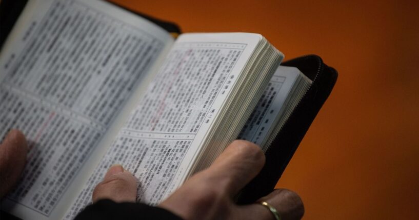 A worshipper holds a copy of the Bible while attending a church service ahead of Christmas in Hong Kong on Dec. 23, 2018, during which several members of the congregation wore black in support of underground churches in mainland China.