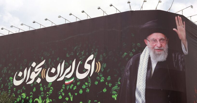 This picture shows a billboard bearing the portrait of Iranian supreme leader Ayatollah Ali Khamenei and a quote reads in Persian "Sing Oh Iran" at the Enqelab Square in Tehran on July 9, 2025.