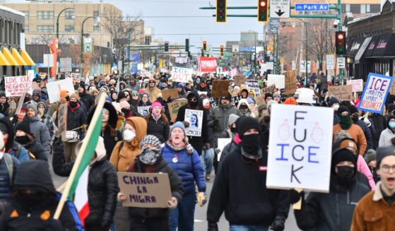 Protesters hold signs as they march from Powderhorn Park in Minneapolis against Immigration and Customs Enforcement and the fatal shooting of Renee Good by an ICE agent, calling on federal authorities to leave the city and demand accountability, in Minneapolis, Minnesota, on Jan. 10, 2026.