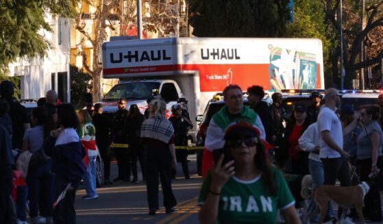 People walk near a U-Haul truck that reportedly was driven into a crowd during an anti-Iranian regime rally on Jan. 11, 2026, in Los Angeles, California.
