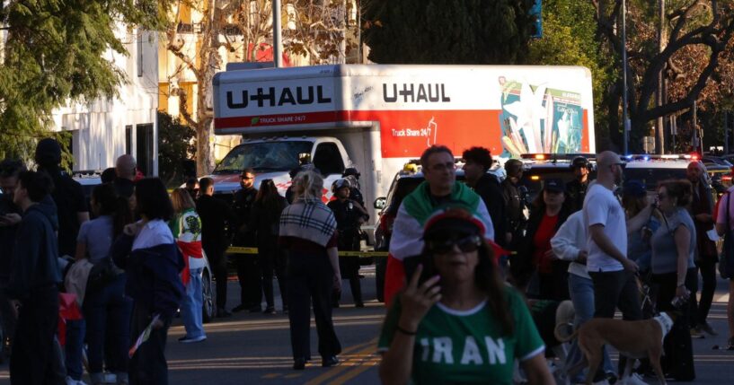 People walk near a U-Haul truck that reportedly was driven into a crowd during an anti-Iranian regime rally on Jan. 11, 2026, in Los Angeles, California.