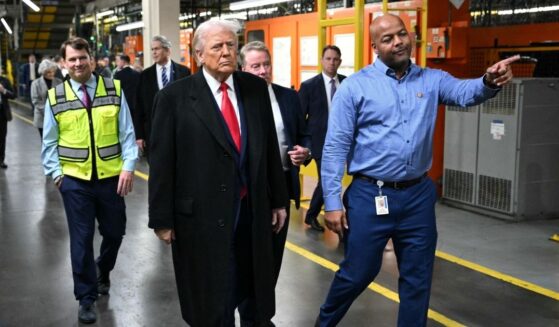 President Donald Trump, alongside Ford CEO Jim Farley, Treasury Secretary Scott Bessent, Ford executive chairman Bill Ford, and plant manager Corey Williams, tours Ford Motor Company's River Rouge complex in Dearborn, Michigan, on Jan. 13, 2026.