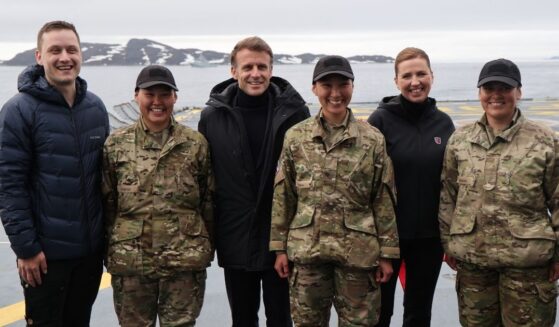 French President Emmanuel Macron, Danish Prime Minister Mette Frederiksen, and Prime Minister of Greenland Jens-Frederik Nielsen pose with military personnel on board the Danish frigate F363 Niels Juel in Nuuk, Greenland, on June 15, 2025.