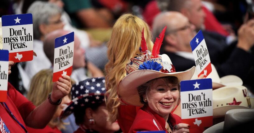 Delegates from Texas hold signs that read "Don't Mess with Texas" on the second day of the Republican National Convention on July 19, 2016, at the Quicken Loans Arena in Cleveland, Ohio.