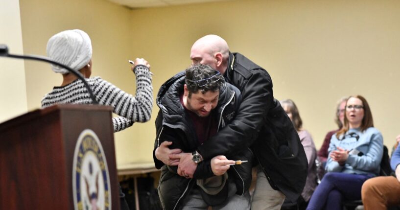 A man is tackled after spraying an unknown substance at Rep. Ilhan Omar during a town hall she was hosting in Minneapolis, Minnesota, on Jan. 27, 2026.