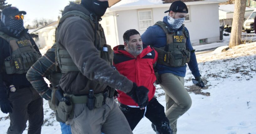 Federal immigration agents detain a man during an operation by Immigration and Customs Enforcement and Border Patrol in St. Paul, Minnesota, on Jan. 27, 2026.