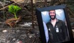 A photograph of 37-year-old Alex Pretti can be seen at a makeshift memorial in the area where he was shot dead by federal immigration agents earlier in the day in Minneapolis, Minnesota, on Jan. 24, 2026.