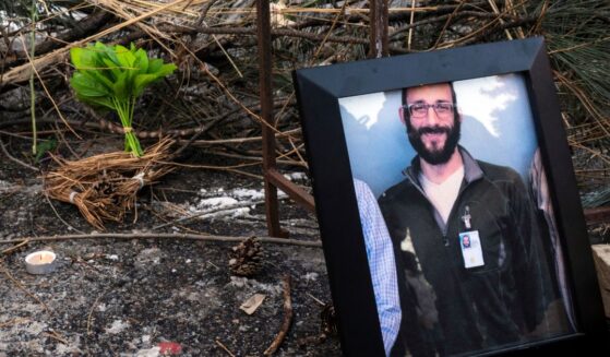 A photograph of 37-year-old Alex Pretti can be seen at a makeshift memorial in the area where he was shot dead by federal immigration agents earlier in the day in Minneapolis, Minnesota, on Jan. 24, 2026.