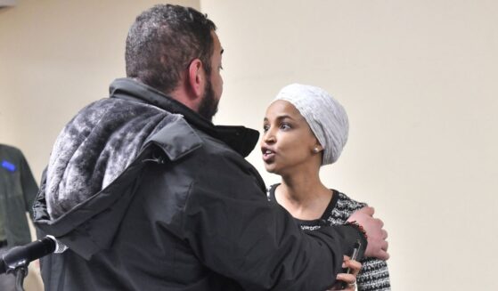 Rep. Ilhan Omar reacts after being sprayed with an unknown substance by a man as she hosted a town hall in Minneapolis, Minnesota, on Jan. 27, 2026.