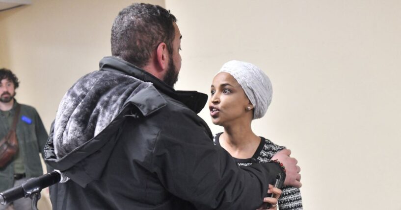 Rep. Ilhan Omar reacts after being sprayed with an unknown substance by a man as she hosted a town hall in Minneapolis, Minnesota, on Jan. 27, 2026.