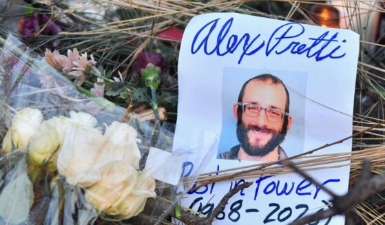 Flowers are left at a makeshift memorial in the area where Alex Pretti was shot dead a day earlier by federal immigration agents in Minneapolis, Minnesota, on Jan. 25, 2026.