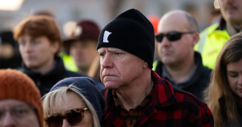 Minnesota Gov. Tim Walz and his wife Gwen Walz look on during a vigil for Renee Good on the steps of the state capitol building on Jan. 9, 2026, in St. Paul, Minnesota.