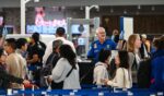 A TSA agent works at a security checkpoint as travelers wait in line at George Bush Intercontinental Airport in Houston, Texas, on Nov. 7, 2025.