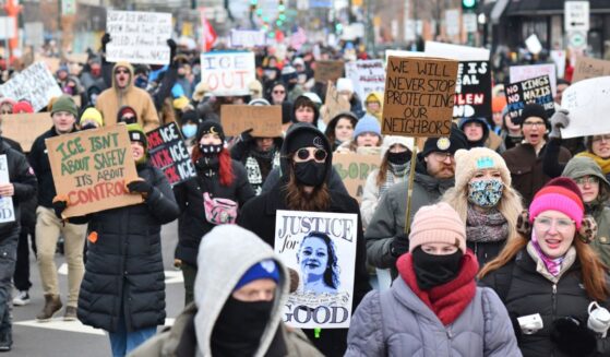 Protesters hold signs as they march from Powderhorn Park in Minneapolis against Immigration and Customs Enforcement and the fatal shooting of Renee Good by an ICE agent, calling on federal authorities to leave the city, in Minneapolis, Minnesota, on Jan. 10, 2026.