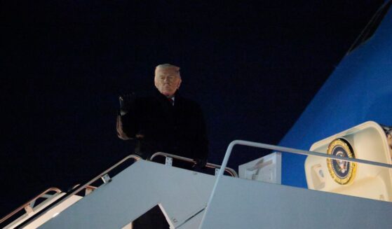 President Donald Trump gestures as he boards Air Force One as he leaves Washington for Switzerland on Jan. 20, 2026, in Joint Base Andrews, Maryland.