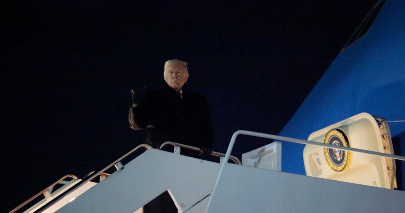 President Donald Trump gestures as he boards Air Force One as he leaves Washington for Switzerland on Jan. 20, 2026, in Joint Base Andrews, Maryland.
