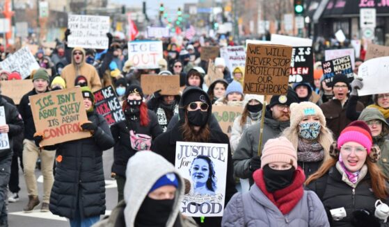 Protesters hold signs as they march from Powderhorn Park in Minneapolis against Immigration and Customs Enforcement and the fatal shooting of Renee Good by an ICE agent, calling on federal authorities to leave the city and demand accountability, in Minneapolis, Minnesota, on Jan. 10, 2026.